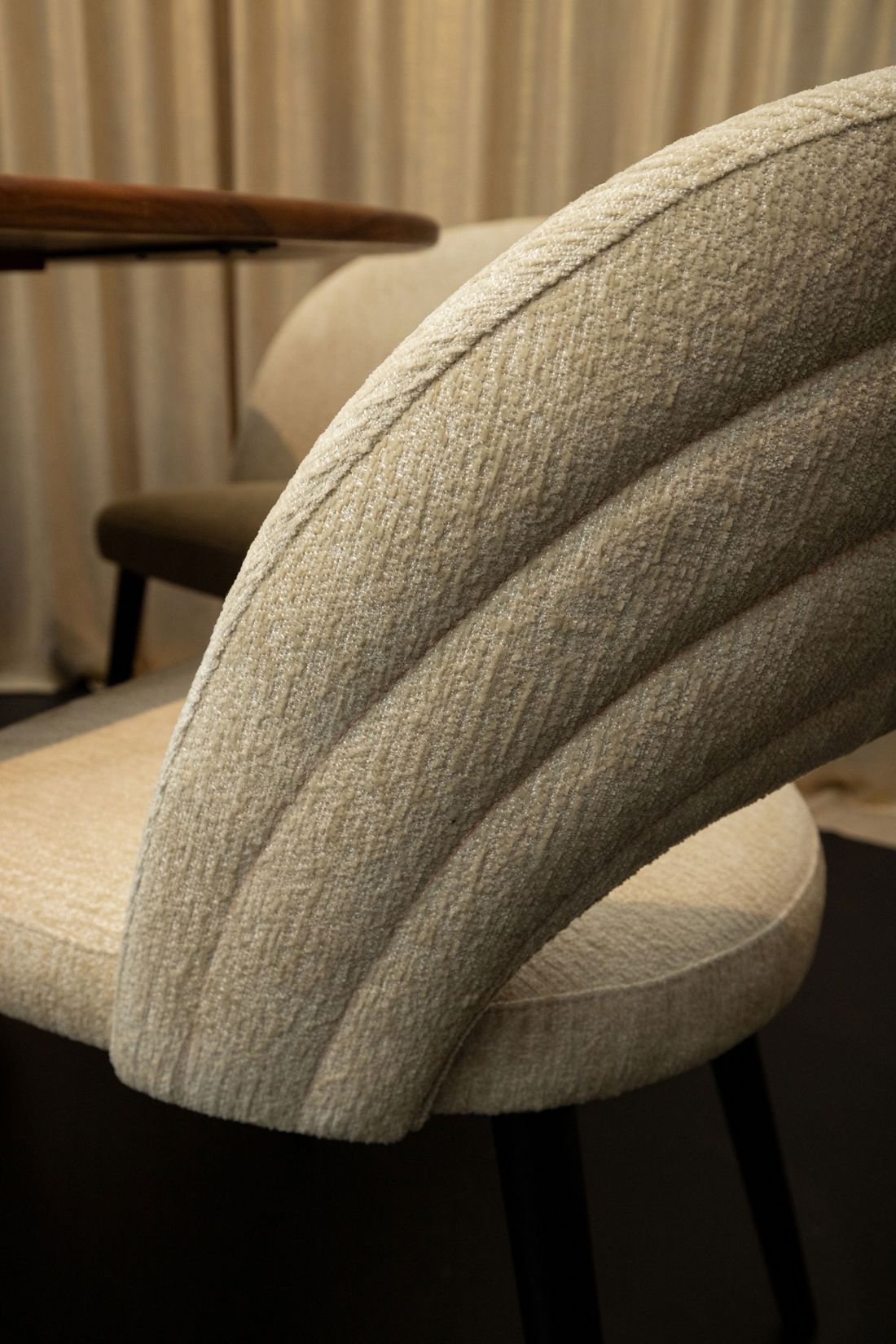 Esszimmerstuhl Abierto mit samtartigem Stoffbezug und schwarz lackierten Beinen.