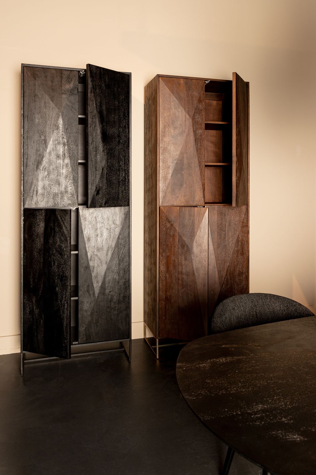 Onyx 4-Türiger Hochschrank in edlem Schwarz, präsentiert neben einem stilvollen Interieur mit Pflanzendekoration