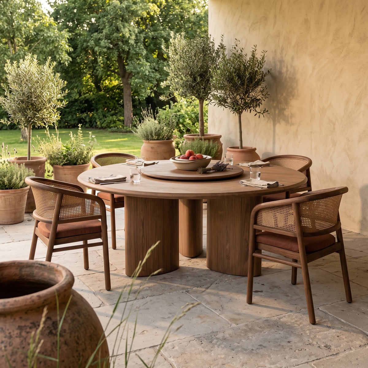 Drehteller Lazy Imen Teak Emas Brown von Gommaire, Teak Emas Brown, Ø 100 × H 3,5 cm, auf dem Esstisch Imen rund mit Armlehnenstühlen Imen und Schale Ali auf der Gartenterrasse